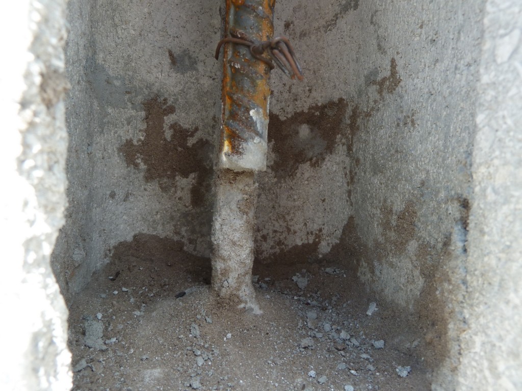 Close up of CMU clean out CMU concrete masonry wall opening for vertical reinforcement steel clean out cleanout