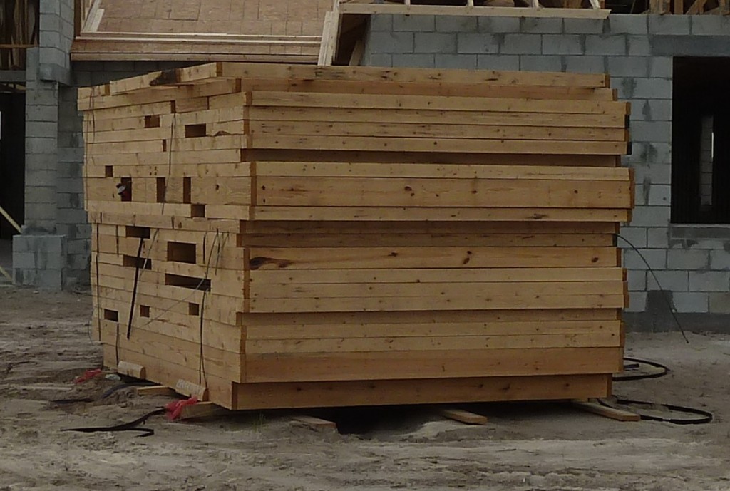 Prefabricated 2x4 wood framed walls stacked on jobsite