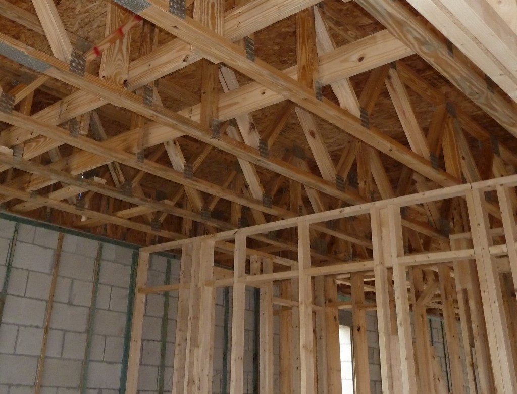 prefabricated wood floor trusses web bearing over top plate of interior load bearing wall